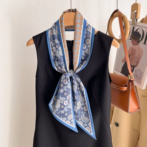 Blue and beige paisley silk scarf with vintage floral patterns tied on a black dress