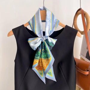 Artistic oil painting style silk scarf tied as a bow on a black sleeveless dress