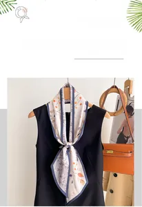 Gros plan du foulard en soie synthétique avec motifs floraux sur un haut noir
