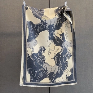 Detailed close-up of navy and beige horse print scarf with refined fringe edges
