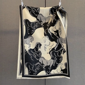 Detail shot of galloping horse print on thick cashmere-like shawl with fringed edges