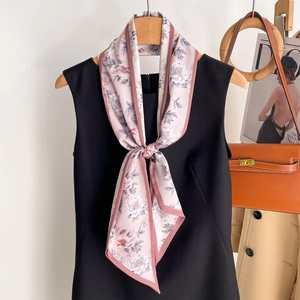 Elegant pink floral narrow silk scarf styled with a black dress and trench coat