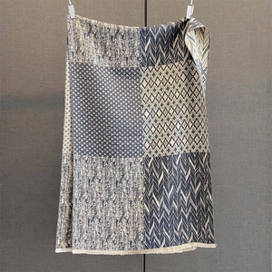 Detailed view of geometric patterns and short fringe on navy blue拼接scaf shawl