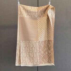 Detail of winter patterned shawl with brown feather motifs and delicate fringed edges