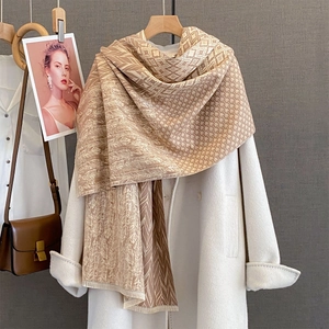 Autumn cashmere-like scarf with geometric leaf pattern draped over a white coat