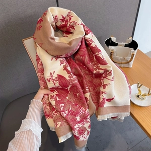 Detail of floral print scarf with soft tassels and rich burgundy patterns