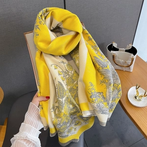 Close-up of vintage yellow and grey floral cashmere scarf with tassel detailing