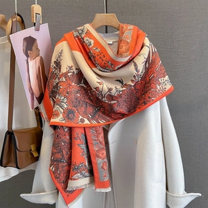 Detail of vintage floral print scarf with tassels on white coat for autumn winter fashion