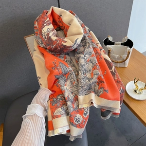 Close-up of vintage floral print scarf with coral orange tones and fine tassels