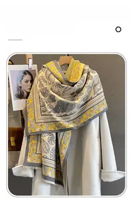 Detailed view of imitation cashmere scarf with seashell print and fringe edge detail
