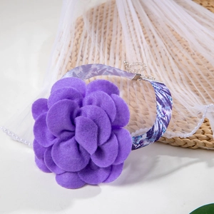 Detail of the purple felt flower choker with printed strap and silver metal chain