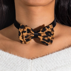 Detail of leopard print bow choker necklace on model with elegant velvet strap