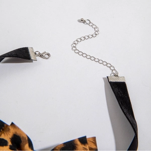 Detailed view of leopard print choker with adjustable lobster clasp and silver chain