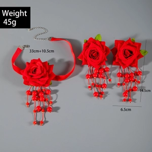 Detailed view of red fabric rose choker and tassels with elegant pearl beaded strings