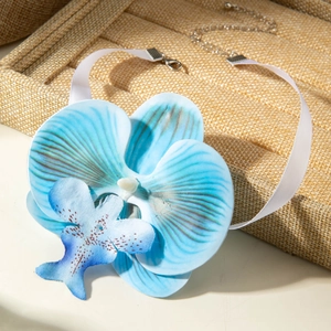 Detail of blue orchid fabric flower necklace with white silk ribbon and adjustable clasp