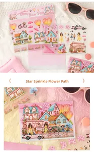 Macro shot of 3pcs dreamy pink hand-drawn stickers featuring houses and hot air balloons