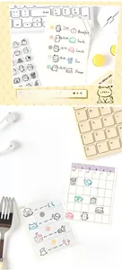 Close-up of cute cat themed scrapbooking cards with schedules and checklist stickers