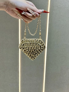 Detail view of champagne gold diamond-shaped evening bag with sparkling crystal embellishments