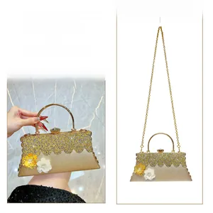 Detail of gold rhinestone evening bag with floral 3D decor and detachable chain strap