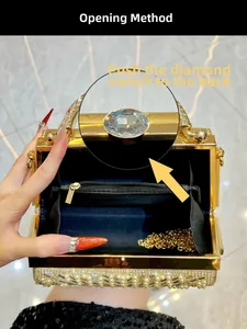 Detail of gold luxury evening bag interior with chain strap and diamond switch mechanism