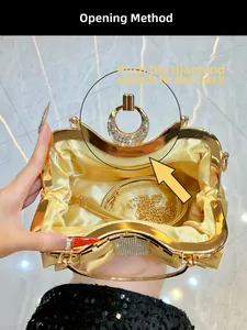Detail of gold evening clutch bag showing satin lining and detachable chain strap