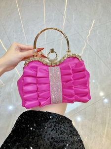 Detailed fuchsia pleated clutch with luxury rhinestone trim and golden metal handle