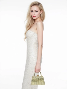 Detail of luxury evening bag with sparkling rhinestones and golden metal handle