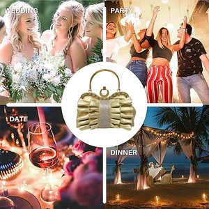 Detail of gold pleated satin evening bag with rhinestone bow and metal handle