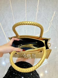 Golden snakeskin texture handbag with rhinestone logo and spacious interior compartment