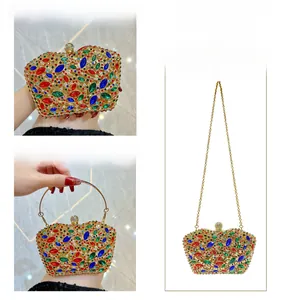 Detail showing colorful marquise crystal embellishments and golden metal handle on bag