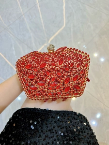 Detail of red luxury evening bag with hand-set crystals and gold metal frame