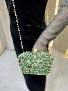 Detail of green marquise crystals and gold chain on luxury rhinestone evening clutch bag
