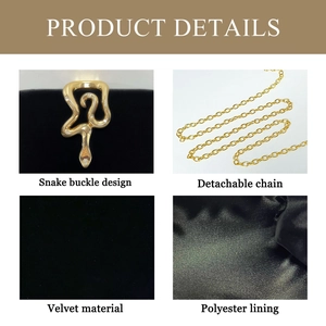 Detailed view of luxury black velvet evening bag featuring gold snake clasp and chain strap