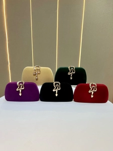 Elegant velvet evening clutch bags with snake-shaped metal clasps in various colors