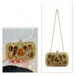 Gold crystal evening clutch bag shown in both handheld and crossbody chain styles