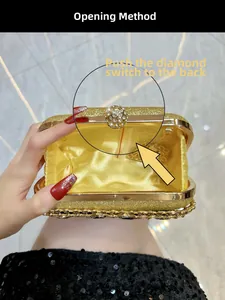 Detailed view of golden evening clutch featuring rhinestone clasp and chain strap