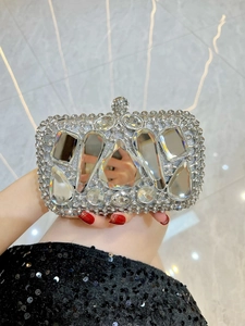 Detailed view of silver crystal clutch bag with large faceted gemstones and ball clasp