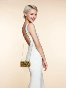 Champagne gold evening clutch with crystal rhinestones on a white dress model