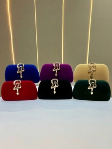 Elegant velvet clutch bags with snake shaped gold buckles in multiple colors