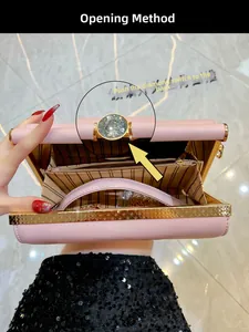 Pink evening clutch with gold metal frame, diamond clasp, and chain strap inside detail