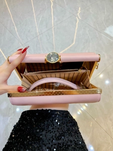 Pink evening clutch bag with crystal clasp and gold chain strap shown open with interior