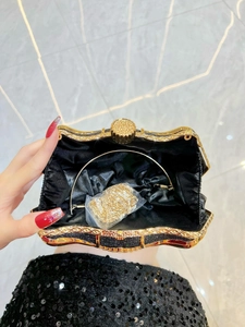 Elegant black glitter evening clutch with gold metal frame and detachable chain strap