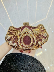 Close-up of heart-shaped evening clutch with red glitter and sparkling teardrop rhinestones