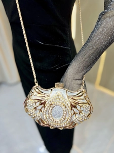 Detail of elegant evening clutch featuring shimmering rhinestones and gold chain strap