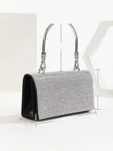 Detail view of rhinestone evening clutch with dimensions 17.5x10x6cm and silver handle