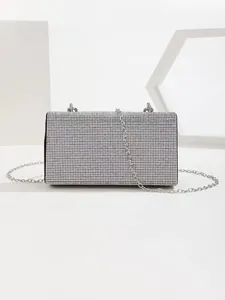 Detail of silver rhinestone evening clutch bag with sparkling stones and metal chain