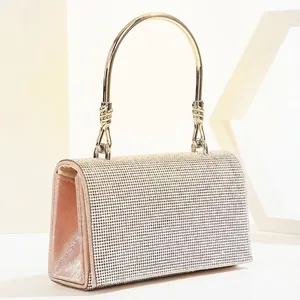 Silver rhinestone evening clutch bag with round gold metal handle for formal gala wear