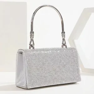Elegant silver rhinestone evening bag with twisted metal handle and crystal flap cover