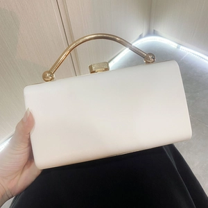 Elegant white rectangular evening clutch with pleated texture and golden metal handle