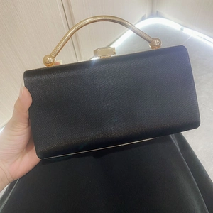 Elegant black rectangular evening clutch bag with vertical textures and gold metal handle